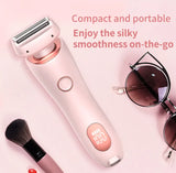 Compact hair removal device with sunglasses and makeup brush on a pink background