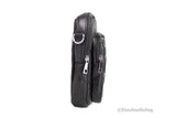 Black leather crossbody bag with multiple zippers on a white background