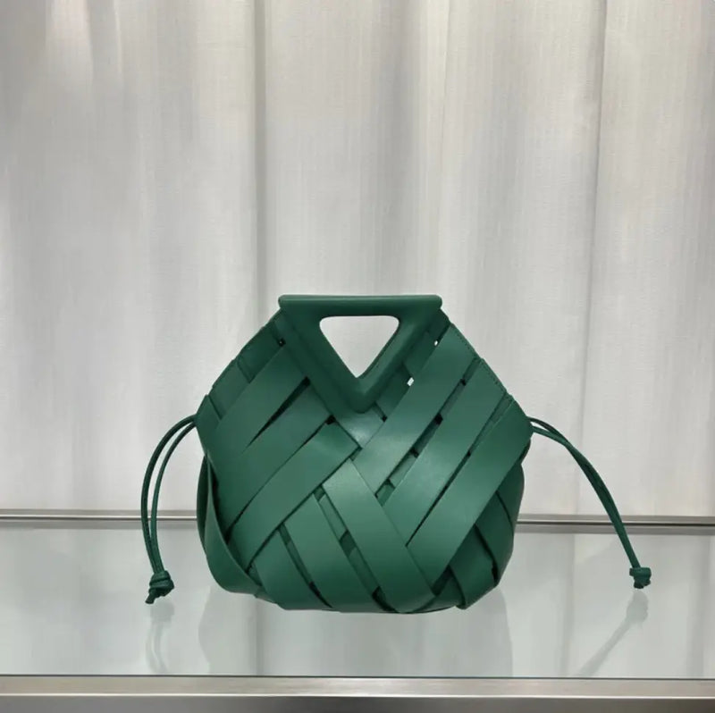 Green woven handbag on a white background