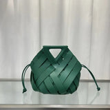 Green woven handbag on a white background
