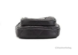 Black quilted handbag on a white background